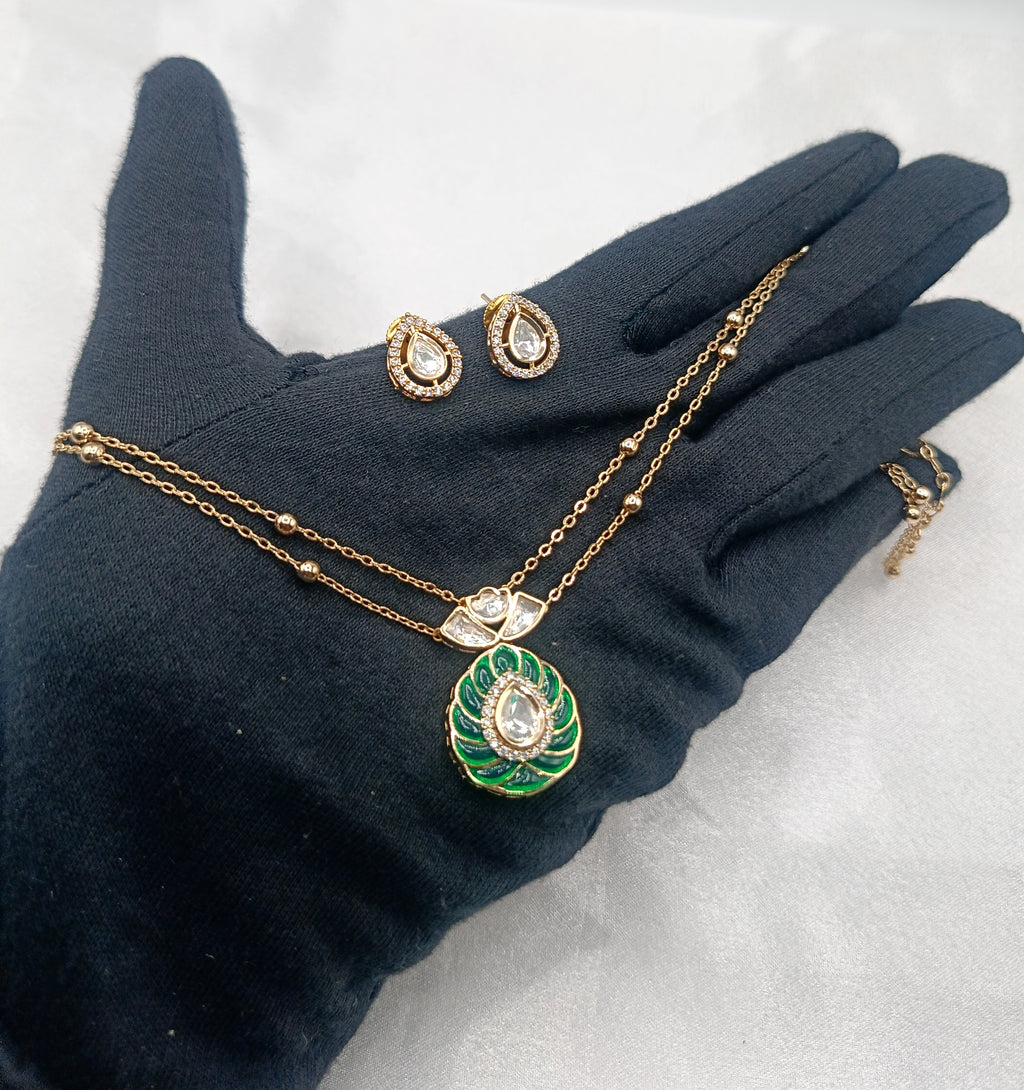 Alisha Emerald Brass Gold Plated Kundan Moissanite Double Chain Pendant Set